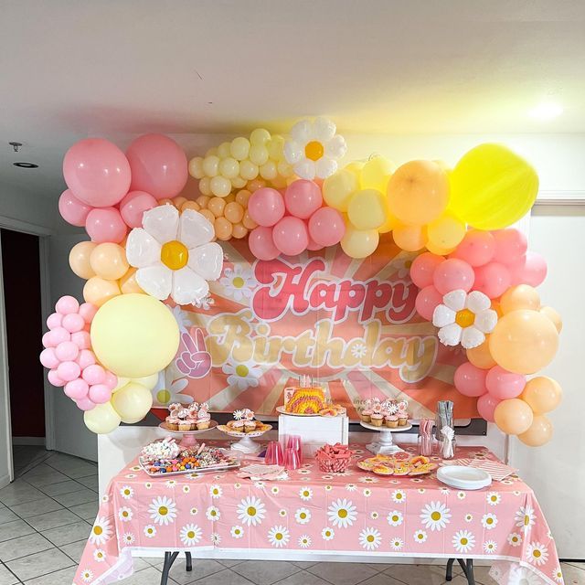 a birthday party with balloons, cake and cupcakes