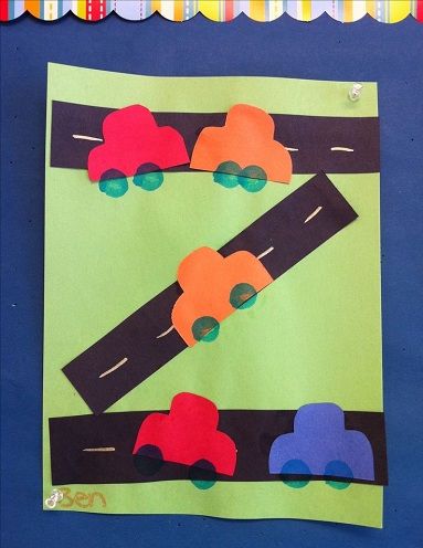 this is an art project for kids to do with construction paper and construction vehicles on the road