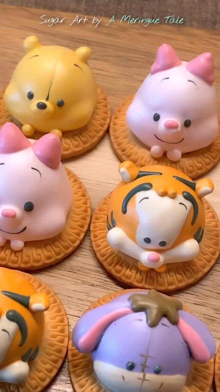 twelve winnie the pooh cupcakes on top of each other with different faces