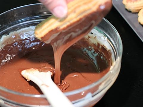 someone is dipping some kind of chocolate in a bowl