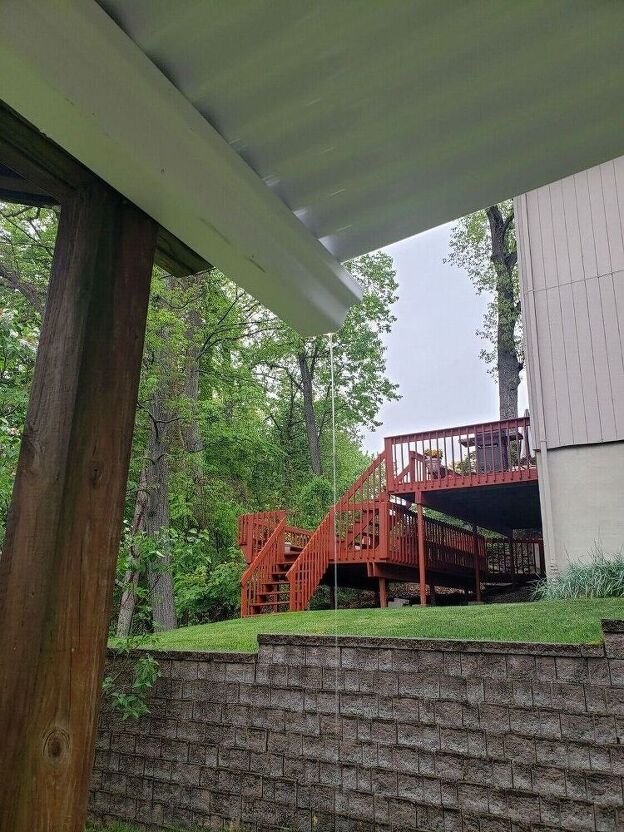 a house with a deck and stairs in the back yard