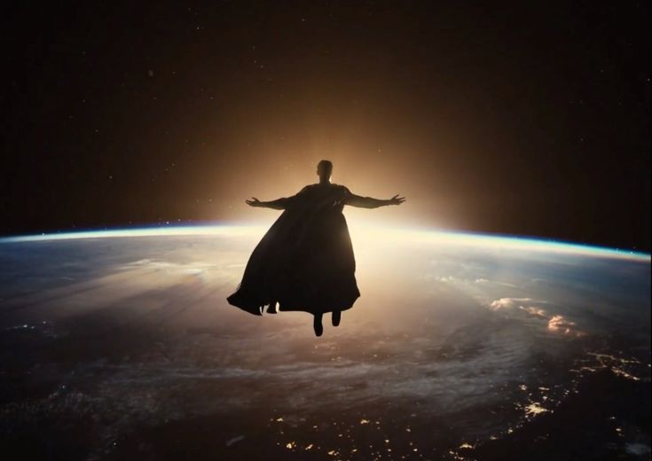 the man is flying in the air above the earth with his arms spread wide open