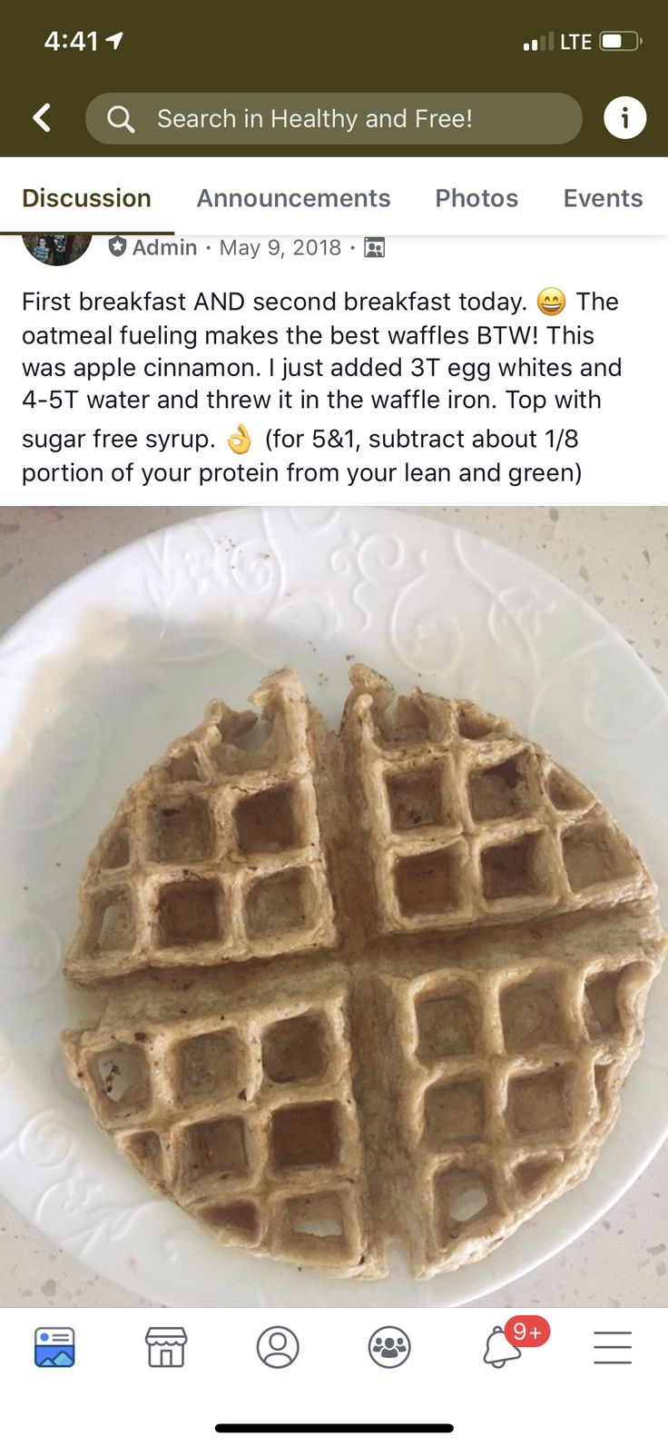 a white plate topped with waffles on top of a counter next to a phone