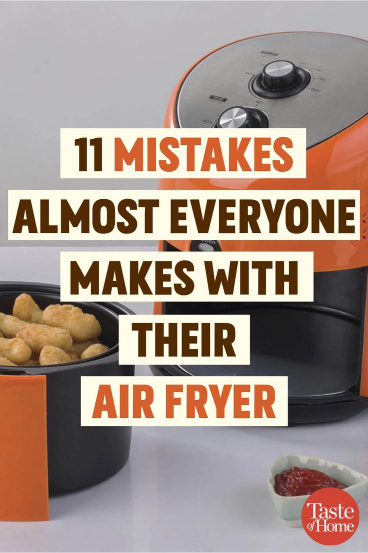 an orange and black air fryer sitting on top of a counter