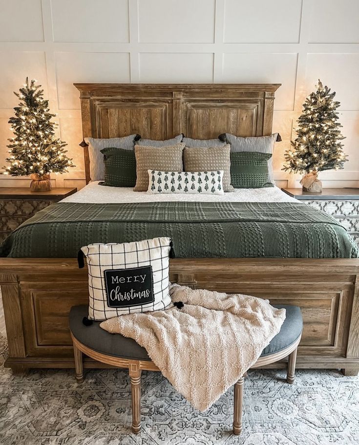 a bed with pillows and blankets on top of it in a room decorated for christmas