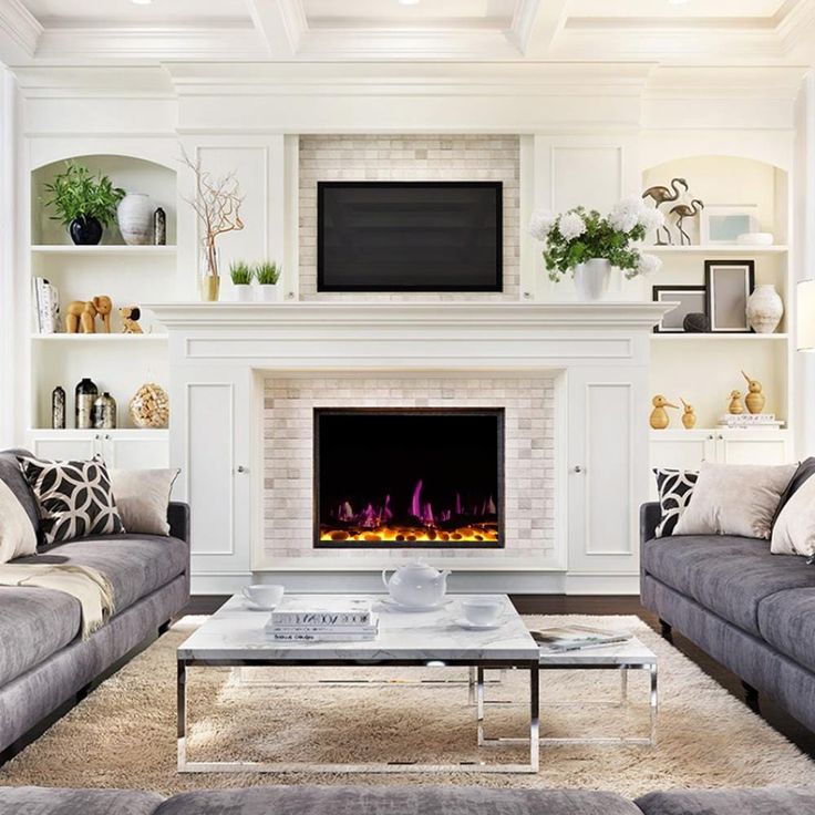 a living room with two couches and a fire place in the middle of it