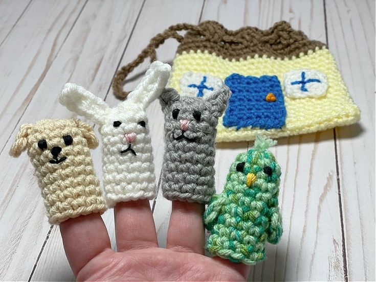 four crocheted finger puppets in the shape of animals