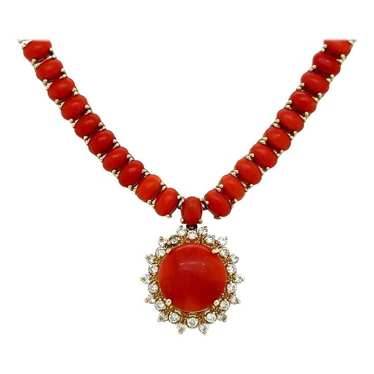 One elegant necklace crafted in 14k yellow gold. The necklace show cases cabochon cut coral gemstones that display a vibrant rich red color. The coral gemstones are perfectly matched and lay seamlessly on the neckline. The coral gemstones accent the yellow gold mounting perfectly as they contrast beautifully with the rich gold color. Highlighting the necklace is the pendant section of the piece. One large round button shape coral gemstone showing an approximate 8.01 carat weight. The center gem Gold Necklace Pendant, 14k Yellow Gold Necklace, Coral Gemstone, Yellow Gold Necklace, The Coral, Round Button, Necklace Craft, Elegant Necklace, Elegant Necklaces