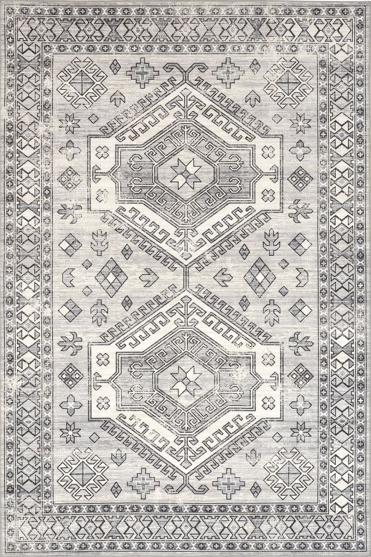 a gray and white rug with an intricate design