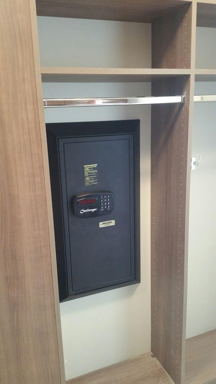 an electronic device is mounted to the wall in a closet that has shelves and shelving