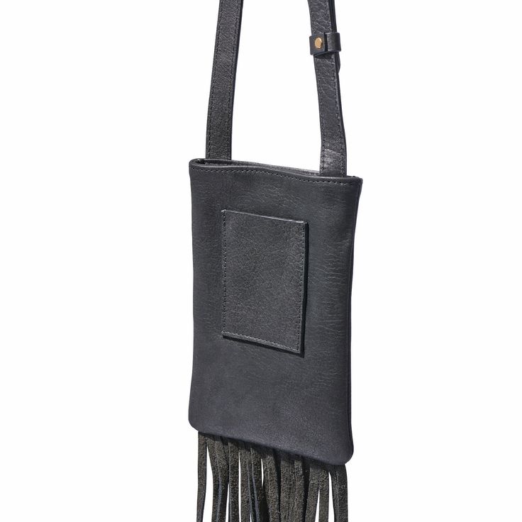 Fringe Phone Bag – Handcrafted in Regenerative American Leather Discover the perfect blend of beauty and practicality with our luxuriously soft Fringe Phone Bag. Designed to comfortably hold your phone, keys, and everyday essentials, this stylish bag features a magnetic snap closure to keep your items secure. Key Features: Spacious Interior: The fully lined interior includes a convenient card pocket on the backside, providing organized storage for your essentials. Unique Design: Showcasing long,