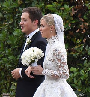 the bride and groom are walking together