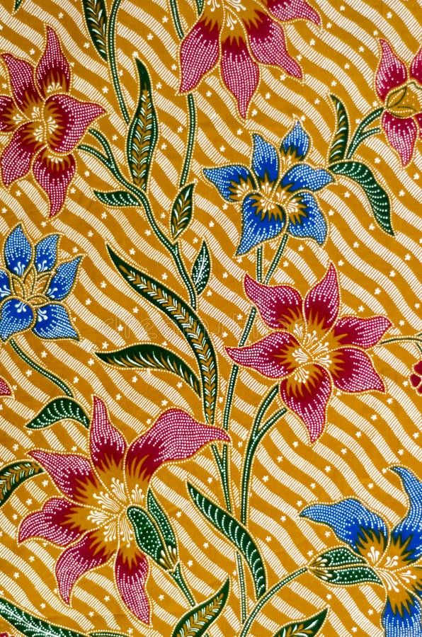 an orange and blue flowered fabric with stripes