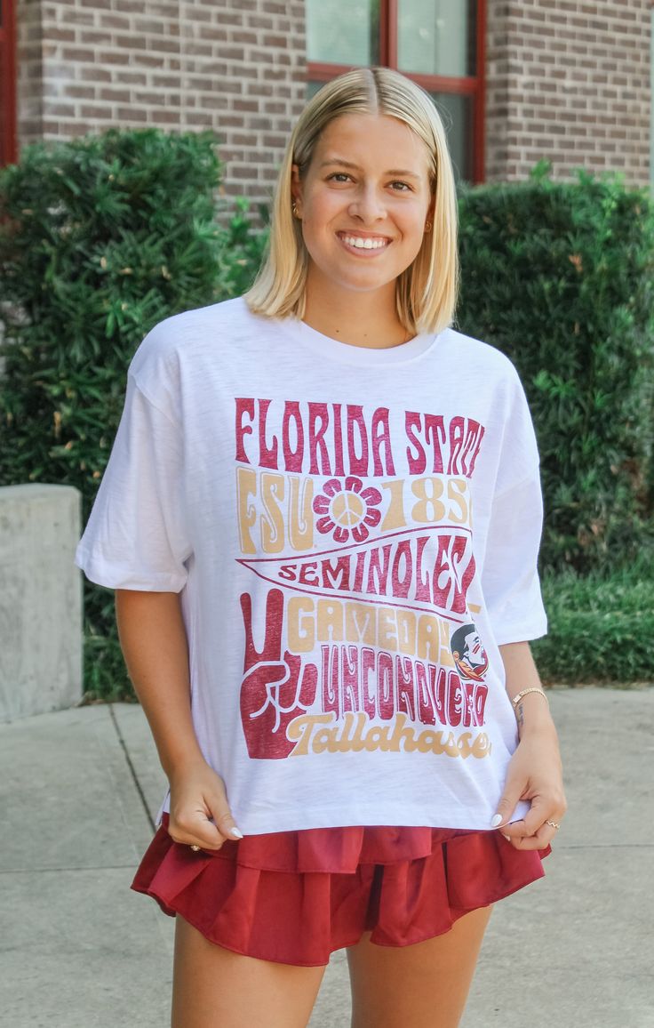 Let your inner hippie vibe shine in the Florida State "Meadow" Oversized Slub Tee. This knit tee brings the groovy retro feels to game day, with its oversized fit and vintage-inspired graphic. It's the perfect mix of comfort and style for all your game day adventures. Peace, love, and Go Seminoles! Details: *OFFICALLY LICENSED* Soft, slub knit tee Fabric content Crew Neckline, Short Sleeve, Waist Length, Boxy Cut Features oversized Retro Font graphic center chest Color: White True to Size: Oversized Fit Madi is wearing size Small Garment measurements in inches: Small = Medium = Large = X- Large = Have questions about sizing, fit, or styling? Send us a chat or give us a call at 850-629-4890 during business hours 11AM - 5PM EST Monday-Friday! Tallahassee Florida, Font Graphic, Groovy Retro, Florida State University, Fashion Bottoms, Retro Font, Alabama Crimson, Alabama Crimson Tide, Florida State