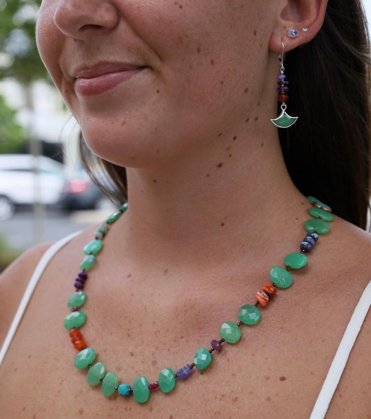 Riverstone Jewelry designer Jill Scholsohn creates vibrant jewelry using a mixture of amulets & talismans along with rare, exotic beads and mediums from sourced from several cultures spanning the globe. Chrysoprase, green, blue & purple turquoise, spiny oyster shell, peridot, carnelian, garnet Adjustable 20.5-23" Long Sterling silver lobster clasp & extender All natural stones, slight variations in color will occur Handmade in CT Green Jade Gemstone Beaded Necklace, Green Gemstone Beads Necklace For Healing, Green Jade Beaded Necklaces With Natural Stones, Jade Jewelry With Natural Stones For Meditation, Jade Gemstone Beads Jewelry For Meditation, Spiritual Amazonite Jewelry With Gemstone Beads, Spiritual Amazonite Gemstone Beads Jewelry, Spiritual Green Amazonite Beaded Necklaces, Healing Amazonite Hand-strung Jewelry