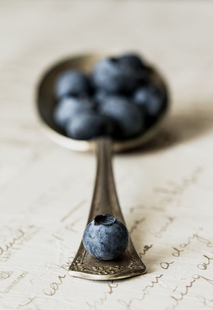 a spoon with some blueberries on it