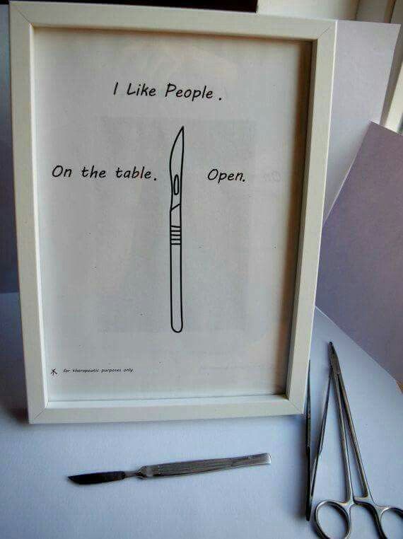 a framed poster with a knife on it and scissors next to it that says, i like people on the table open