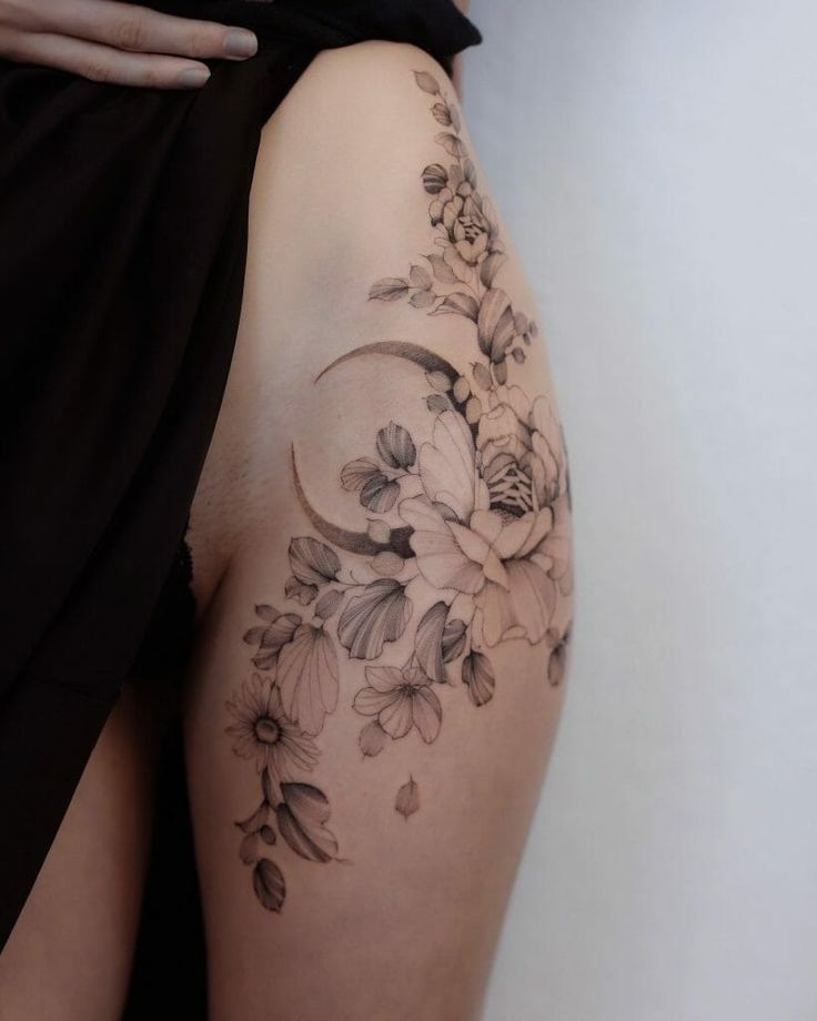 a woman's thigh with flowers on it