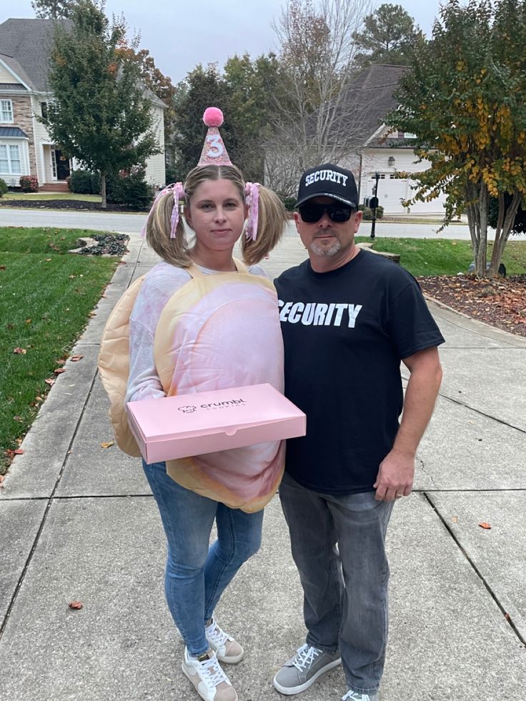 a man standing next to a woman in a costume