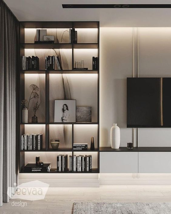 an image of a living room with bookshelf and tv on the wall in it