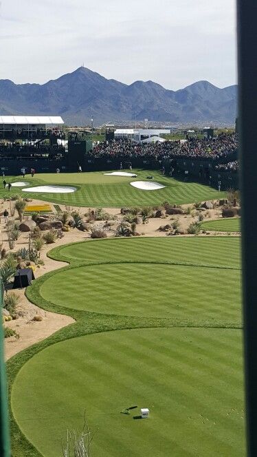 a golf course with mountains in the background