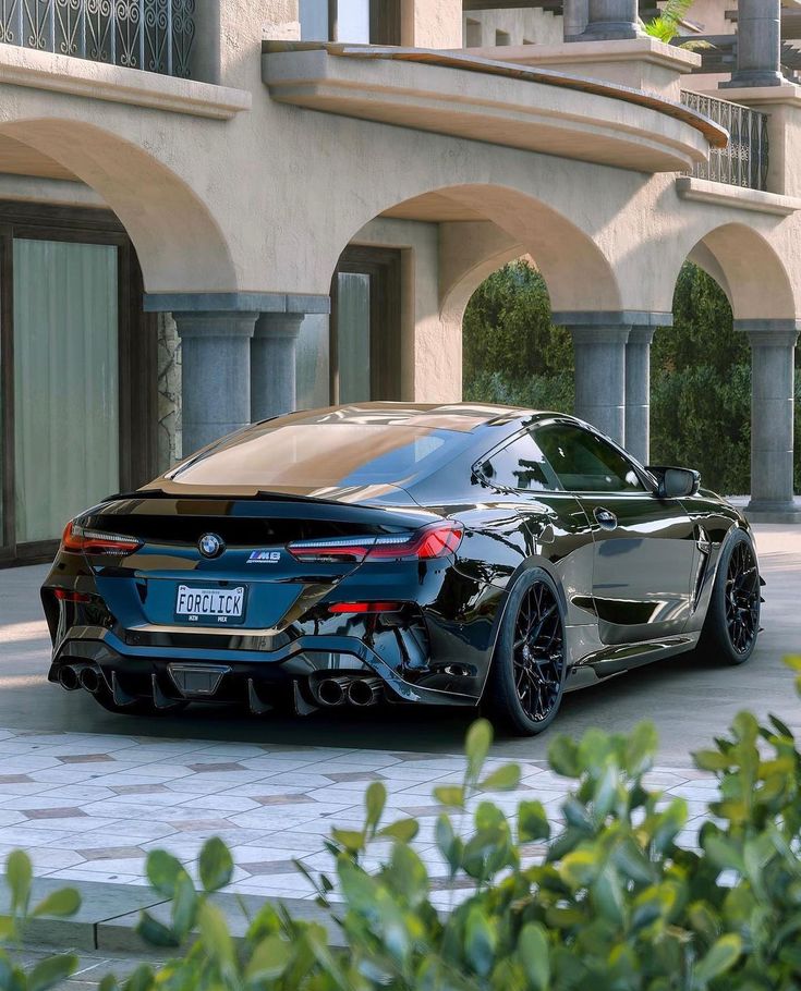 a black sports car parked in front of a building