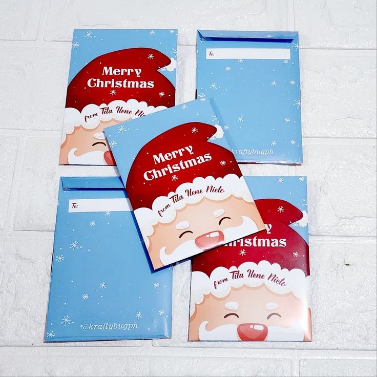 four envelopes with santa claus on them