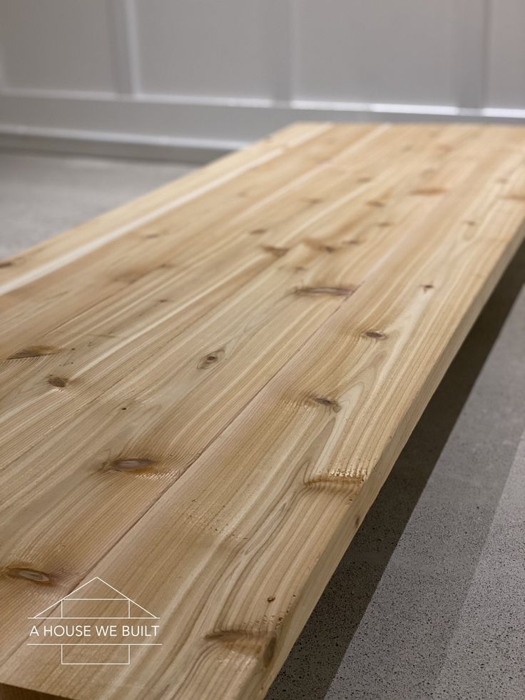 a wooden bench sitting on top of a carpeted floor