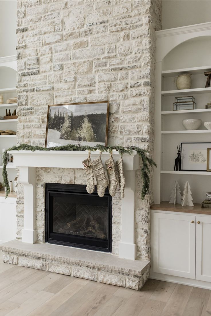 a living room with a fire place and white brick fireplace mantel covered in christmas stockings