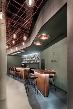 the interior of a restaurant with wooden tables and bar stools