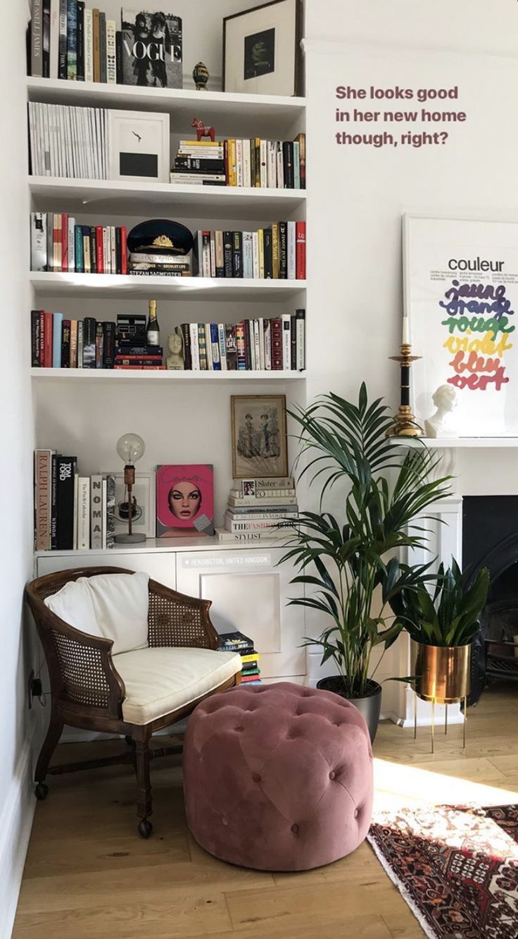 a living room filled with lots of books and furniture