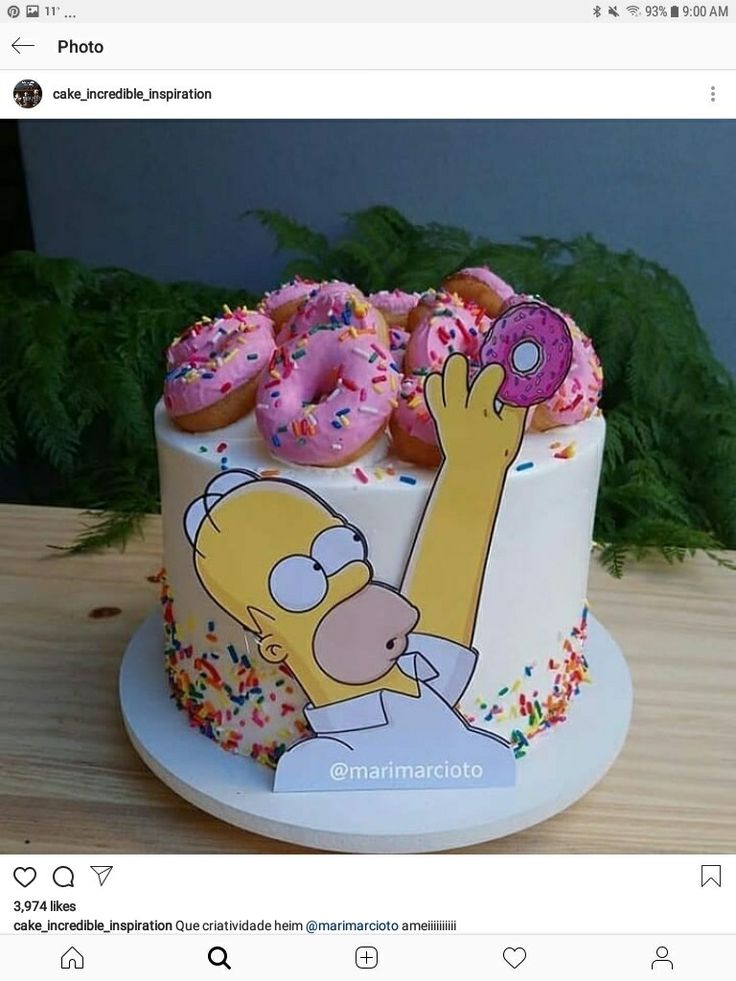 a simpsons cake with donuts and sprinkles