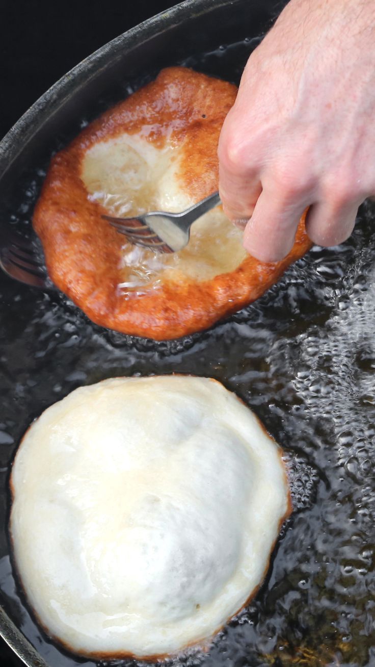 a person is frying an egg on top of some bread in a skillet