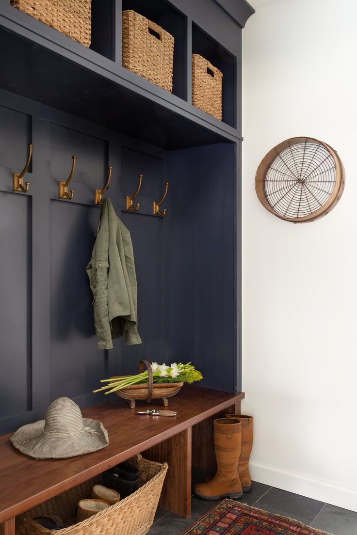 a coat rack with hats, shoes and other items on it next to a bench