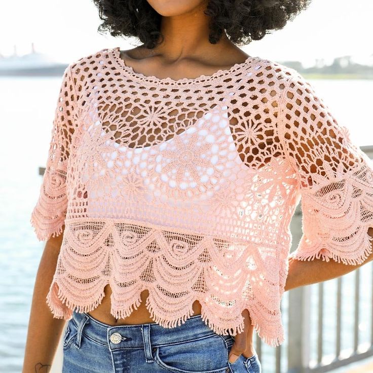 Get ready to turn heads in this stunning Crochet Crop Top. Perfect for those hot summer days, this top is designed to keep you cool and stylish. The beautiful scalloped details give it a sophisticated and high-end look, making it a versatile piece for both casual and dressy occasions. Pair it with high-waisted shorts or a flowy skirt for a flirty and feminine look. Whether you're hitting the beach, going for a night out, or just enjoying a sunny day, this top will elevate your outfit and have yo Chic Summer Crochet Lace Top, Fitted Lace Crop Top For Summer, Feminine Fitted Open Knit Crochet Top, Chic Summer Crochet Top With Crochet Trim, Bohemian Open Knit Top For Summer, Chic Open Knit Crochet Top For Summer, Feminine Summer Beach Crop Top, Chic Open Knit Crochet Top For Beach Season, Chic Crochet Knit Top For Summer