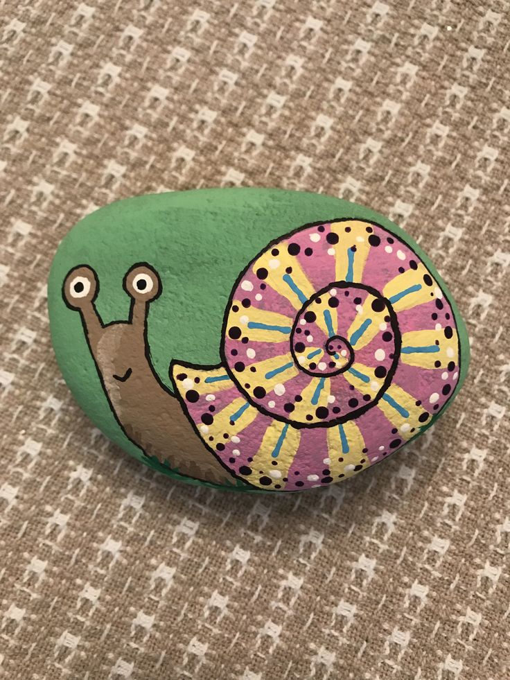 a painted rock with a snail on it