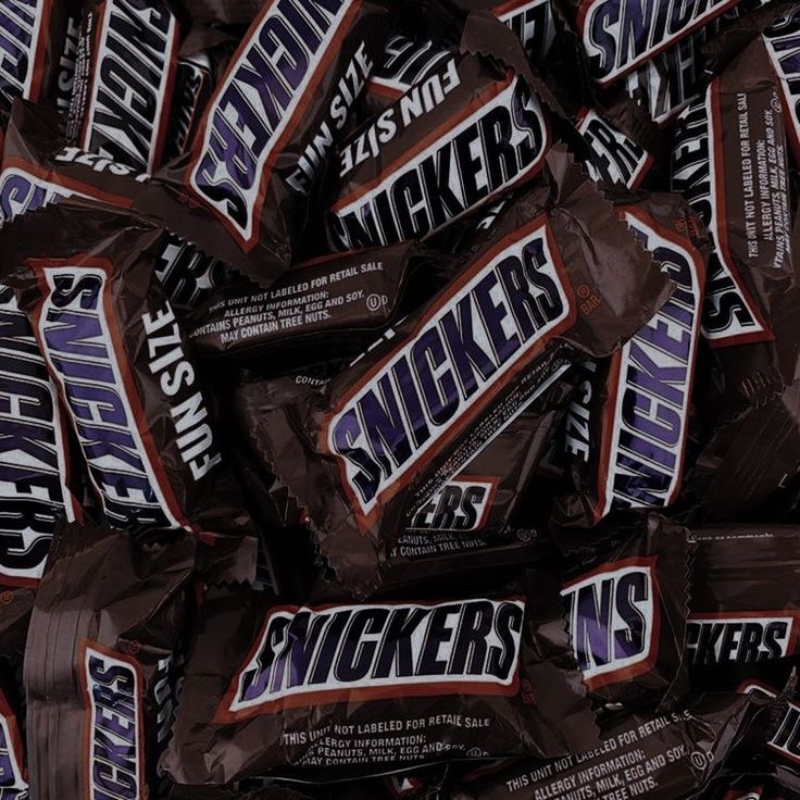 a pile of snickkers chocolate bars sitting on top of each other