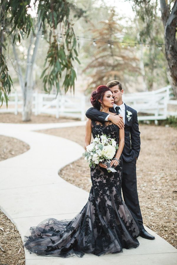 a bride and groom pose for a wedding photo