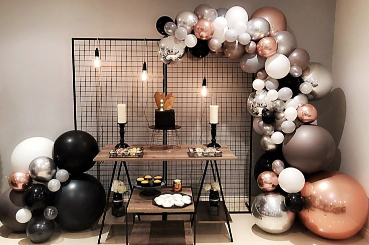 a room filled with balloons and candles next to a table