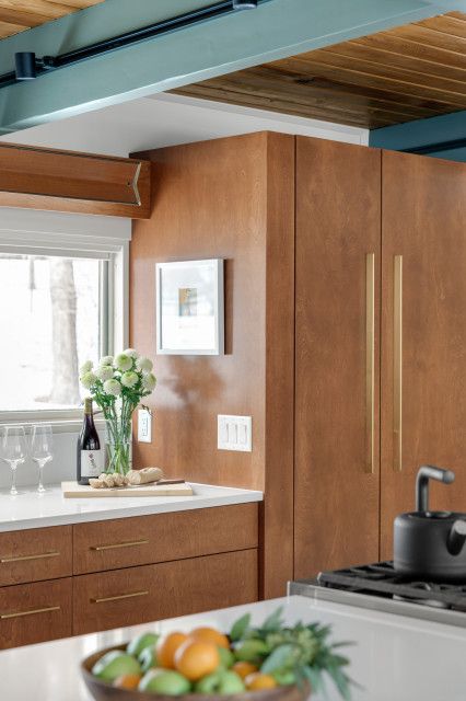 a bowl of fruit sitting on top of a kitchen counter next to a stove top oven