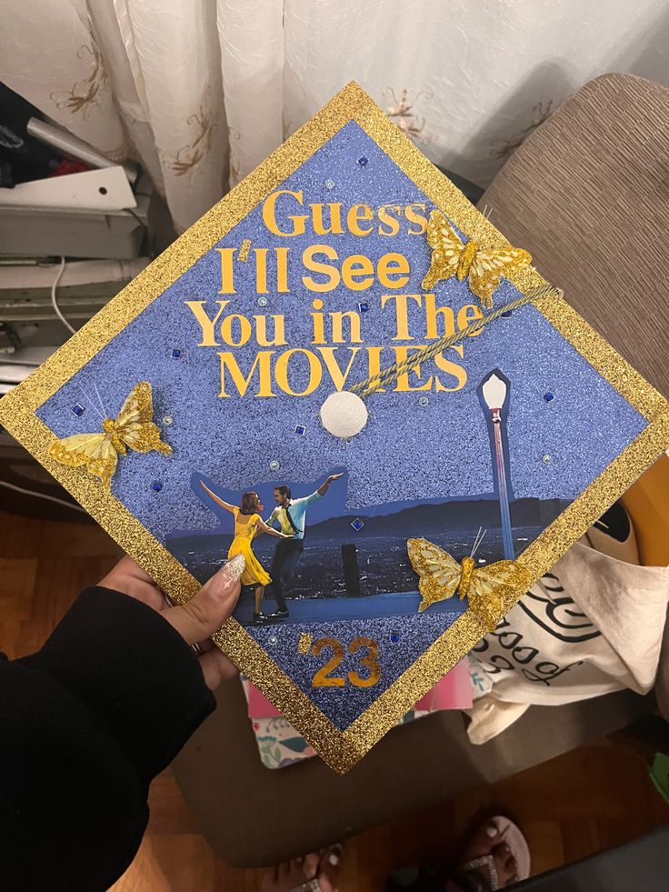 someone is holding up a graduation cap that says guess i'll see you in the movies