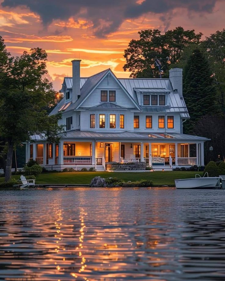 a large white house sitting on top of a lake