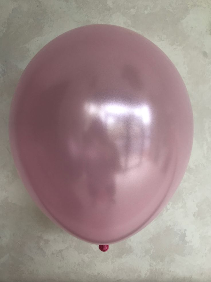 a pink balloon is hanging on the wall