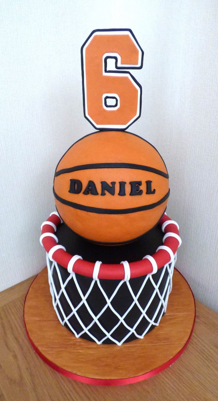 a cake made to look like a basketball and net with the number 6 on it