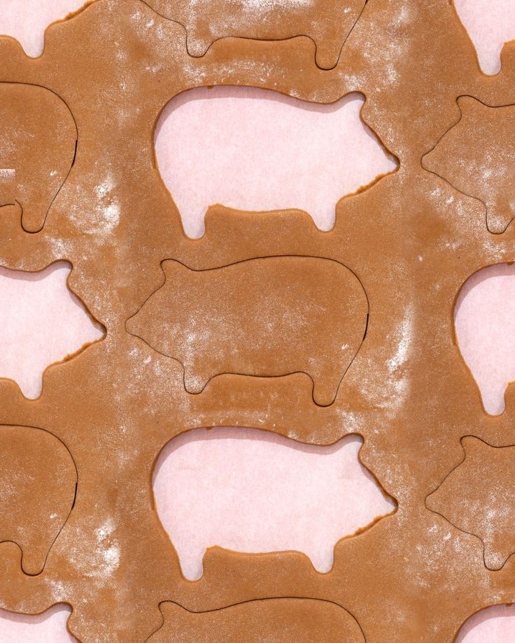 the cookie is shaped like elephants on pink paper and has been cut out to look like bears