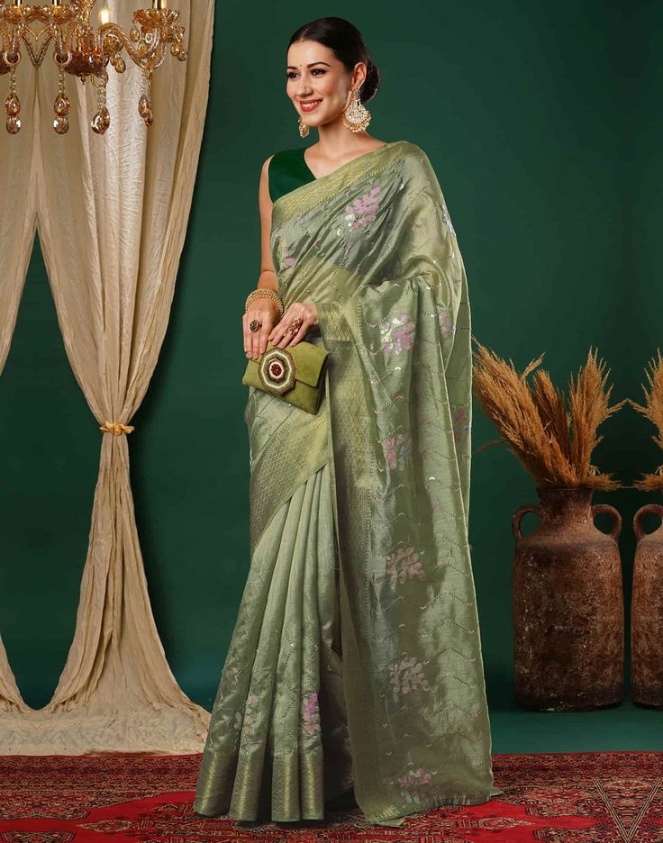 Pista Green Sequence Silk Saree  Pista Green Sequence Silk Saree is a glamorous and sparkling piece. The rich silk fabric drapes beautifully, creating a luxurious and elegant look. The intricate sequence work, which can be arranged in various patterns like floral motifs, geometric designs, or abstract shapes, adds a dazzling shimmer to the saree  Features Of Pista Green Sequence Silk Saree  Traditional Handloom Craft  Intricate Gold Brocade Work  Durability and Longevity   Size Fit  The model height is 5.7 ft   WASH AND CARE  Hand Wash only. Do not dry in direct sunlight    Legal Disclaimer:  The product is guaranteed to be 100% genuine. Product images are for illustrative purposes only. Images/packaging/ labels may vary from time to time due to changes made by the manufacturer's manufactu Festive Pista Green Banarasi Silk Pre-draped Saree, Festive Bollywood Pre-draped Tussar Silk Saree, Elegant Art Silk Pre-draped Saree For Festivals, Elegant Pista Green Pre-draped Saree For Festivals, Elegant Pista Green Dola Silk Pre-draped Saree, Festive Floor-length Silk Blouse Piece, Elegant Green Banarasi Silk Blouse Piece, Pista Green Banarasi Silk Pre-draped Saree For Eid, Bollywood Style Silk Floor-length Blouse Piece