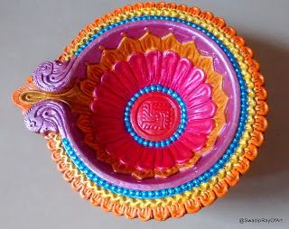 a colorful bowl with an ornate design on the top and bottom, sitting on a table