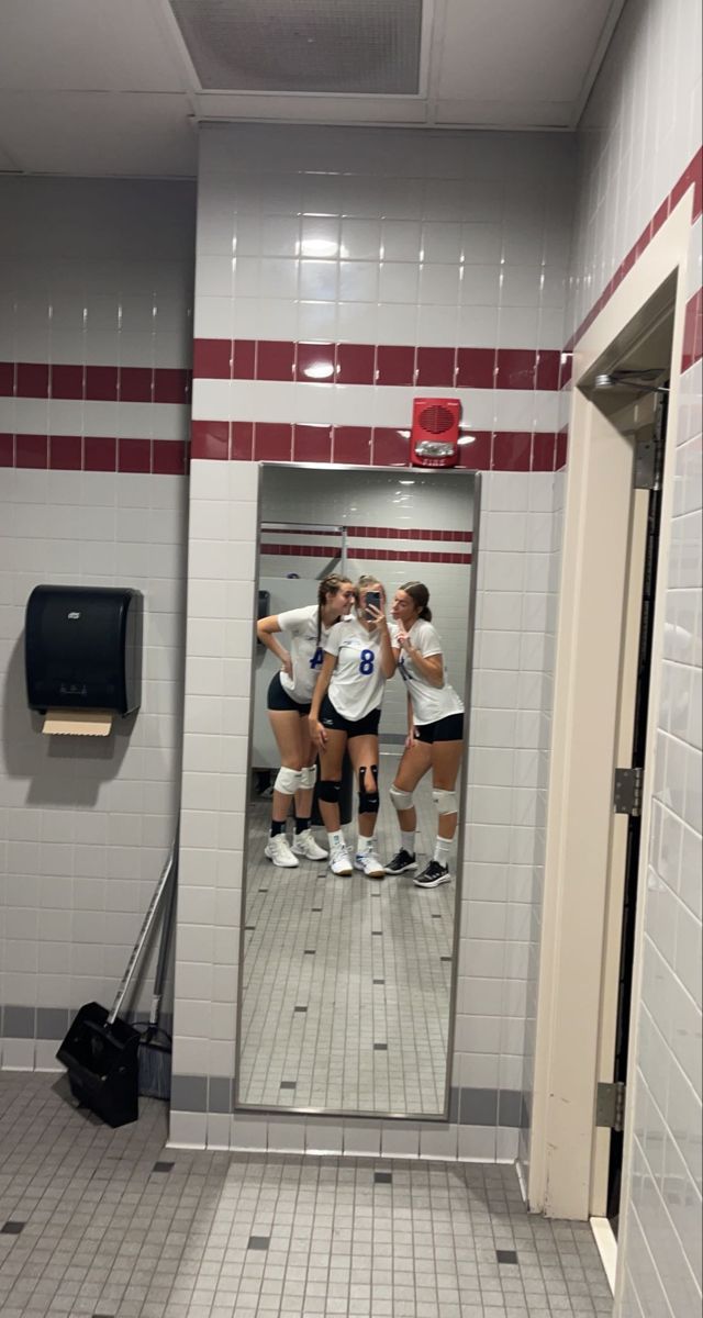 the girls are playing volleyball in the bathroom