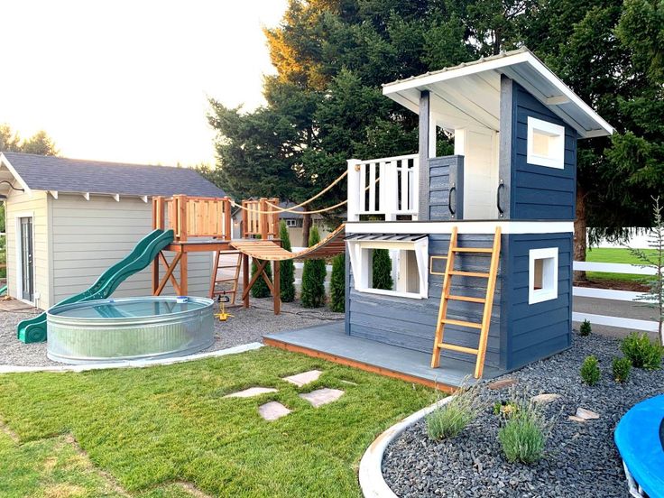 a small house with a slide in the yard