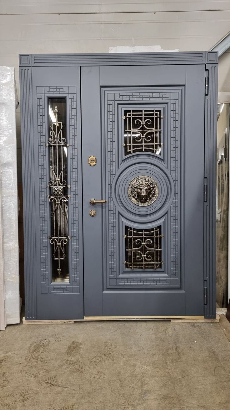 the front door is painted blue and has an intricate design on it's side